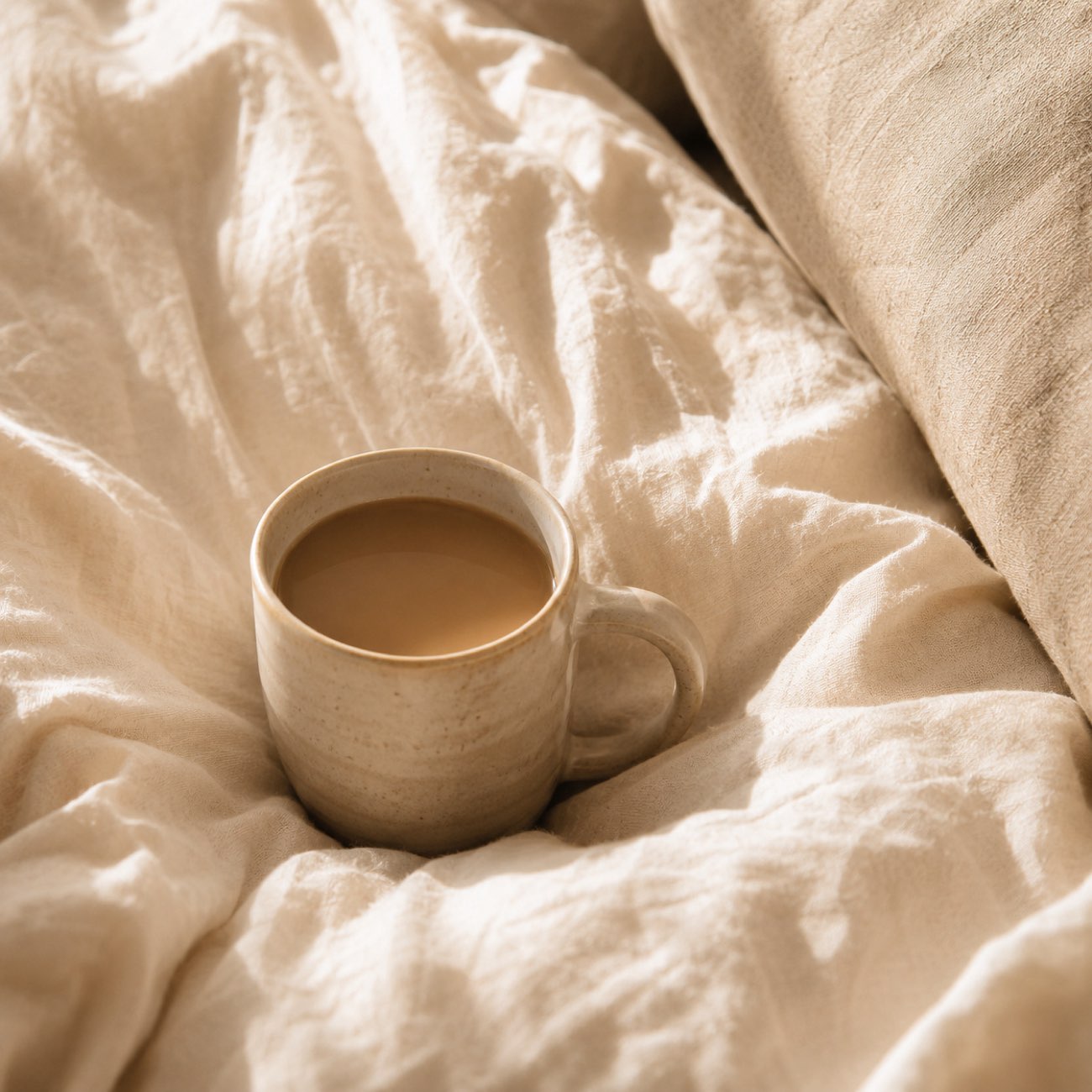 A warm cup on linen in peaceful natural light